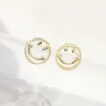 Macro detail of fashionable golden smiley face stud earrings with textured outer rims - Hollow Engraved Smiley Face Style (E0163)