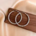 Large silver-toned textured hoop earrings with a metallic crushed-effect finish. - Ripple Hoop Style (E0270) / Silver