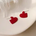 Elegant vibrant red heart-shaped stud earrings featuring a stylish LOVE engraving detail - Red Engraved Heart Style (E0180) / Red