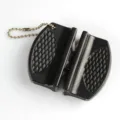Close-up view of portable mini knife sharpener with black diamond textured grip - Black