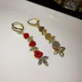 Elegant long drop earrings featuring red rose buds and sparkling crystals in gold setting - Three Roses Long Hoop Earring (E3338)