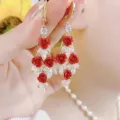 Elegant gold-tone long drop earrings with red rose charms and sparkling white crystals - Three Red Roses Long Dangle Earrings (E3228)