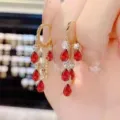 Detail view of gold hoop earrings with cascading red teardrop crystals and clear stones - Teardrop Gemstone Long Tassel Style / Gold Red (E3409)