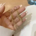 Elegant gold long tassel drop earrings with hoop closure and textured leaf design - Meteor Feather Shaped Tassel Style (E3301 Gold)