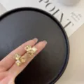 Elegant champagne cubic crystal stud earrings featuring a geometric faceted design. - Elegant Combination (E3855) / Gold Brown