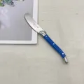 Detailed view of French Laguiole butter knife with blue handle and stainless steel blade. - Blue