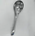 Macro view of a polished stainless steel soup spoon with a sturdy long handle. - Style 1 Rice Spoon