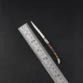 Detailed view of a compact folding pocket knife with wooden handle alongside a ruler for size. - Resin Handle / 130mm