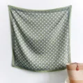 Detailed view of a green and white geometric pattern 90cm square silk-like scarf - 90x90cm / Green