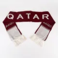Detail view of 16x135cm Qatar flag knitted jacquard acrylic scarf in maroon and white. - Qatar Flag Style / 16x135cm