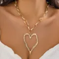 Close-up view of golden lava-textured heart pendant necklace on chunky oval link chain - Single Layer Lava Heart Heavy Chain Necklace / Gold