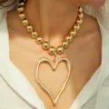 Statement chunky gold bead necklace featuring a large irregular lava heart shaped pendant - Exaggerated Bead Lava Heart Necklace / Gold