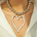Elegant chunky silver beaded necklace featuring a large molten heart pendant on model - Exaggerated Bead Lava Heart Necklace / Silver