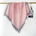 Gros plan d'un foulard carré en coton rose à pois avec une bordure florale paisley - Rose Pois
