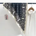 Close-up detail of a vintage blue paisley triangle scarf paired with a white shirt - Triangle Scarf (TBSJJ70) / 87x130cm / Navy Paisley