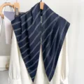 Close-up of navy blue striped triangle scarf elegantly draped on a white blouse for styling - 87*130CM / Navy Stripe