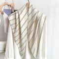 Detail of a vintage striped triangular scarf styled over a white shirt for women - 87*130CM / Beige Striped
