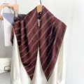 Detailed view of a brown striped triangle scarf draped elegantly over a white blouse. - 87*130CM / Brown Stripes