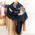 Close-up detail of a vintage leopard print scarf shawl draped over a camel wool coat - Black / 88*188cm