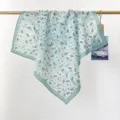 Close-up of a lightweight floral cotton square scarf draped over a minimalist wooden rod. - 65*65cm / Blue