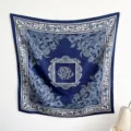 Detail view of navy blue floral printed silk scarf with elegant white borders. - RY-36