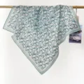 Detail view of a vintage floral cotton square scarf hanging on a gold rod. - RY-07