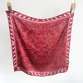 Close-up detail of a luxurious red faux silk square scarf with symmetrical floral patterns. - 65*65 / Red