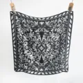 Detailed view of the symmetrical baroque pattern on a black and white faux silk scarf. - 65*65 / Black