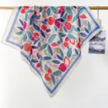Detail of a lightweight cotton square scarf with vibrant floral and leaf patterns - RY-10