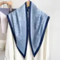 Detail view of light blue paisley triangle scarf draped on a white blouse - 87*130CM / Blue