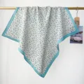 Detail view of a 100% cotton floral paisley print square scarf draped on a gold rod - RY-43