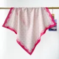 Vue détaillée d'un foulard en coton rose à pois et nœuds suspendu à une tringle - Rose Poudré Pois