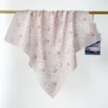 Close-up detail of a soft pink floral cotton square scarf elegantly draped over a hanging rod - RY-21