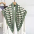 Detailed view of a green and white plaid satin silk triangle shawl on a wooden hanger - 87x130cm / Green