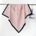 Detailed view of a white cotton square scarf with red floral print and black border - RY-51