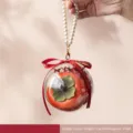 Elegant orange persimmon-shaped wedding candy gift box featuring a white pearl handle - Persimmon Candy Jar with Ball & Pearl Chain