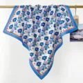 Close-up of blue and white floral cotton square scarf hanging on a wooden rod - RY-31
