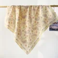 Detailed view of a soft cream cotton square scarf with elegant orange paisley pattern - RY-40