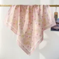 Macro view of the intricate yellow and pink paisley pattern on a cotton square scarf - RY-39
