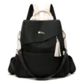 Black anti-theft women's backpack with cream accents and decorative tassel charm - White and Black