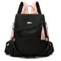 Modern black anti-theft backpack for women with soft pink straps and tassel detail. - Pink and Black