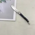 Stainless steel butter knife with black handle and classic bee design, perfect for table use. - Black