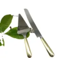 Close-up detail of high quality gold-handled stainless steel cake knife and server set - Knife and Server Set / Gold