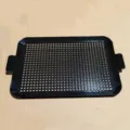 Top view of a black perforated enamel BBQ grill tray with dual handles on cardboard. - Large Size 50x30.2x2cm