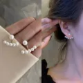 Elegant pearl ear jacket earrings featuring an arc of small pearls in a gold finish. - Curved Pearl Style (E0956) / Gold