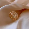 Macro view of a gold-plated adjustable open ring featuring exquisite micro-pave zircon details - Horseshoe Clasp Overlapping Style (J0009) / Adjustable Open