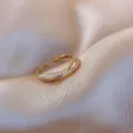 Detailed close-up of a minimalist gold-plated open ring with white pearls and zirconia - Cross Pearl Rhinestone Inlaid Style (J0010) / Adjustable Open