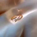 Detail view of rose gold criss-cross open ring with shimmering micro-paved zircons - Cross Asymmetric Micro-Set Style (J0011) / Adjustable Open