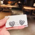 Detail of heart stud earrings with black and white houndstooth pattern on display card - Houndstooth Heart Style (E1880)