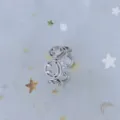 Close-up of a trendy silver-toned open ring with smiley face motifs on starry mesh fabric - Adjustable Open / Linked Smiley Style (J0027) / Silver
